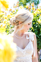 A beautiful bride framed by yellow roses.